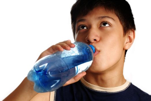 Drinking boy and bottle with mineral water after sport game