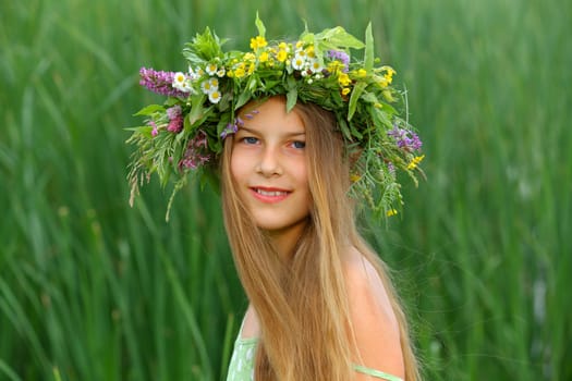 Clouse-up spring portrait beautiful girl with wreath of flowers