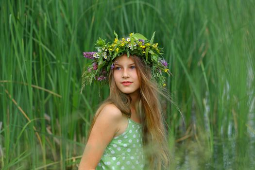 Clouse-up spring portrait beautiful girl with wreath of flowers