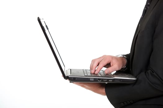 Businessman typing on laptop keyboard