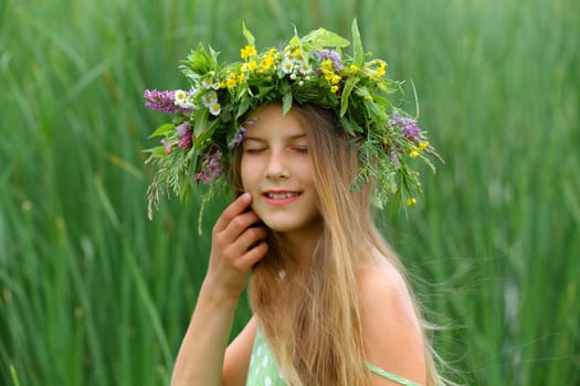 Clouse-up spring portrait beautiful girl with wreath of flowers