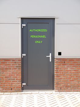 metal door with text authorized personnel only and access control system