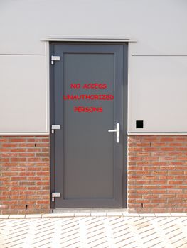metal door with text no access unauthorized persons and access control system