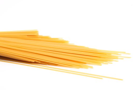 uncooked spaghetti are located right on a white background