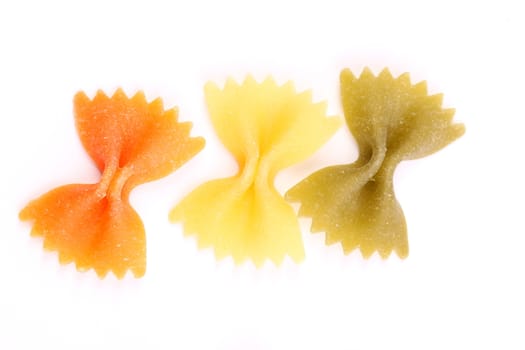 Close-up pasta farfalle three colors are located on the white background.