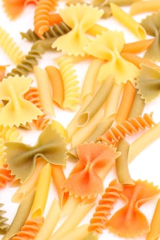 A different pasta in three colors close-up on the white background.