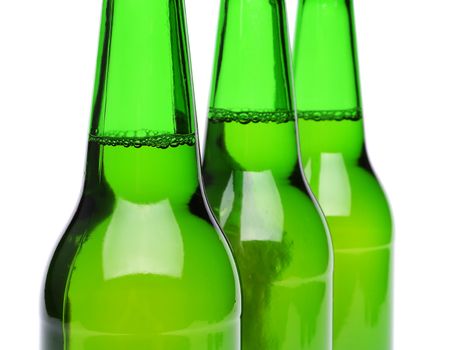 Three bottles of beer close-up on the white backgroun