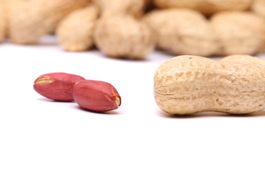 Two peanut kernels and peanut close-up on the white background