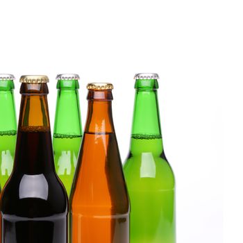 Closed bottles of beer are located left on a white background