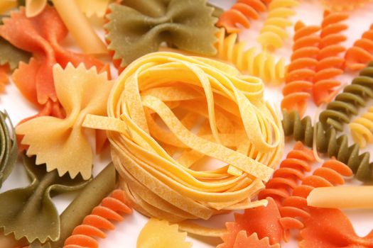 Yellow tagliatelle paglia e fieno on the backgroun of different pastas.