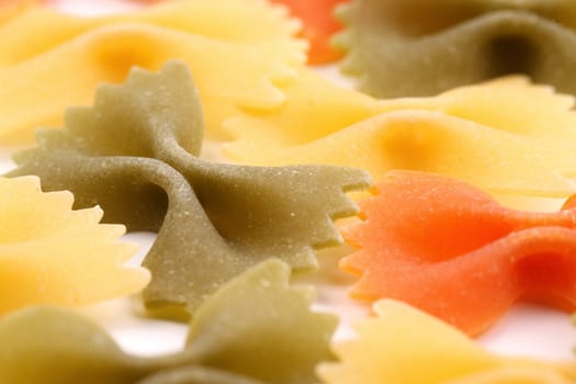 A background of the farfalle pasta three colors close-up.