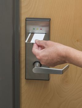 Keycard being inserted in electronic hotel door lock