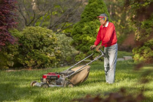 Man mowing the grass in his yard