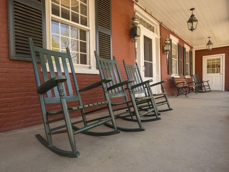 Old fashioned rocking chairs on colonial house porch