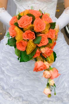 red rose bouquet in girls hand after wedding