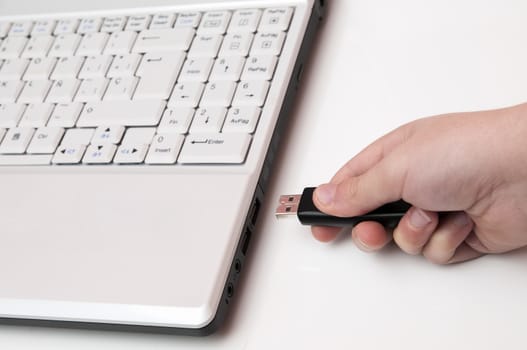 plugging the laptop with a usb on white background