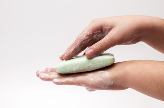 hands with soap on a white background