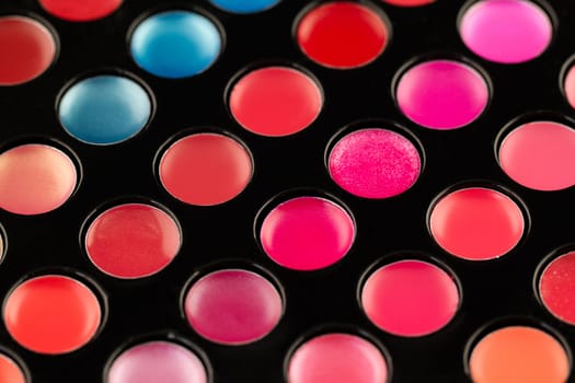 Close-up shot of lip gloss palette, soft focus