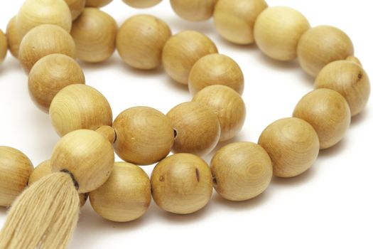 Wooden rosary on white background