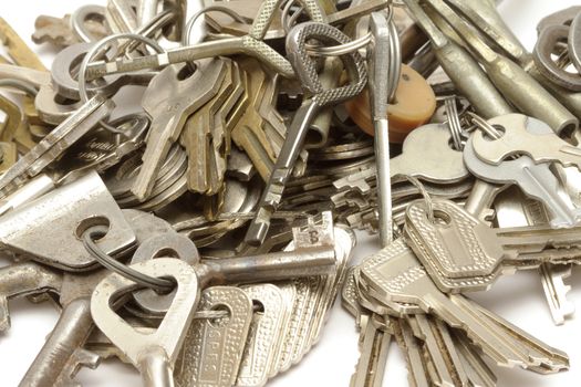 Heap of keys on white