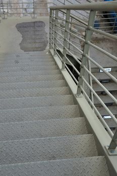 Pedestrian footbridge iron stairway urban overpass bridge above the motorway.