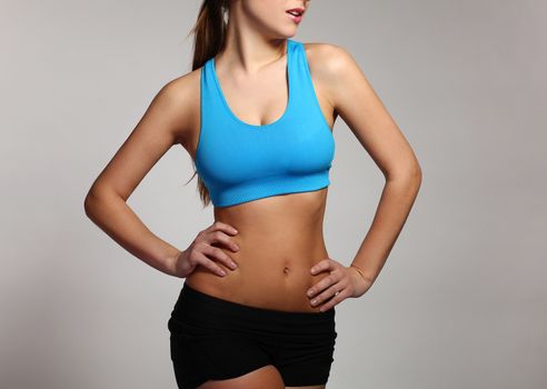 Beautiful caucasian woman's body in a fitness wear