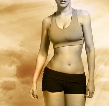Beautiful caucasian woman's body in a fitness wear over sky background