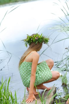 Spring portrait beautiful girl with wreath of flowers. Vertical view