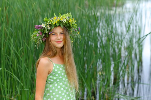 Spring portrait beautiful girl with wreath of flowers
