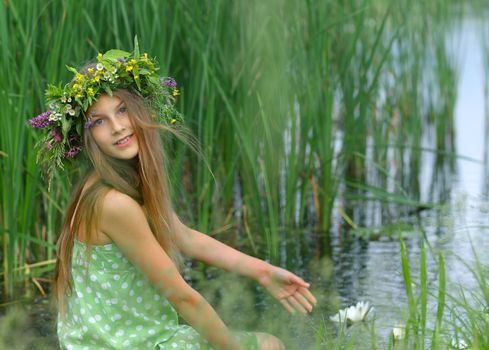 Spring portrait beautiful girl with wreath of flowers