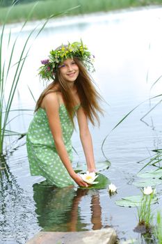 Spring portrait beautiful girl with wreath of flowers. Vertical view