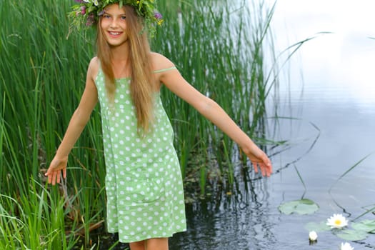Spring portrait beautiful girl with wreath of flowers