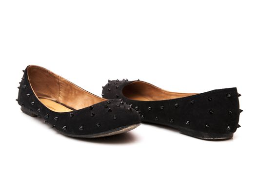 black colored shoes with decorative skewers