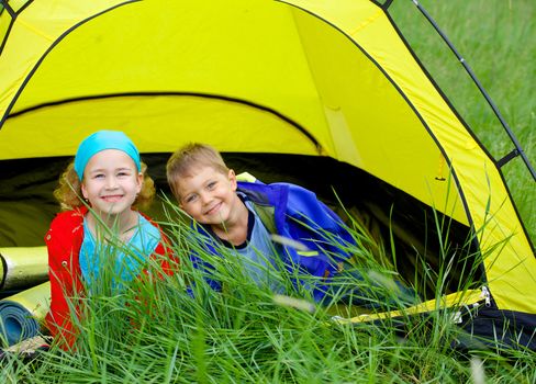 Summer, child camping in tent - lovely sister and brother on camp tent