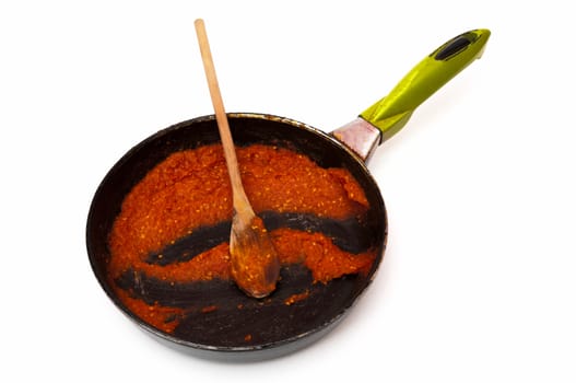 pan with sauce on a white background