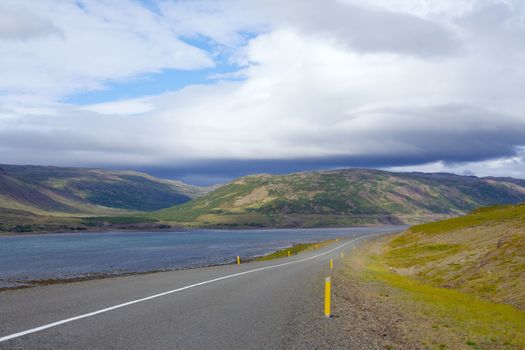 Highway through Iceland landscape at foggy day. Horizontal shot