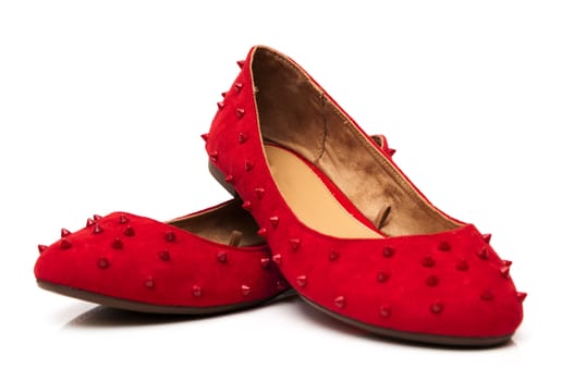 Spiked red shoes on a white background