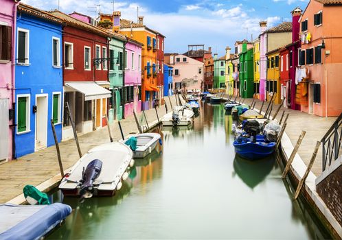 Colorful buildings in Burano island sunny street, Venise, Italy