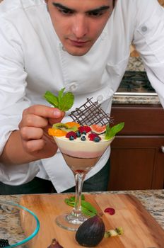 Chef making mousse cake and decorating