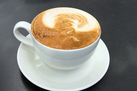 Cup of Espresso Latte in White Cup and Plate Closeup