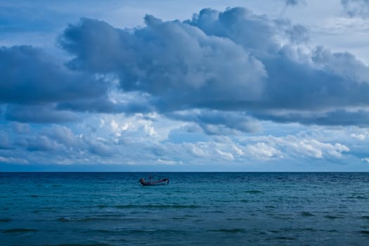 dark cloudy stormy sky with clouds and waves in the sea