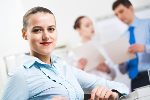 portrait of a business woman in office, smiling and looking into the camera, office work