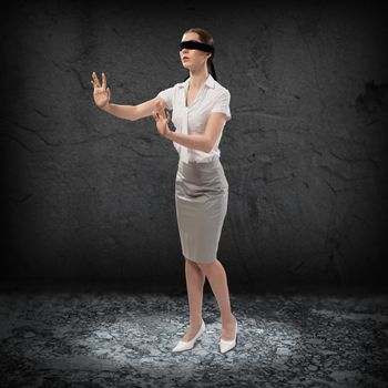 young blindfolded woman. can not find a way out