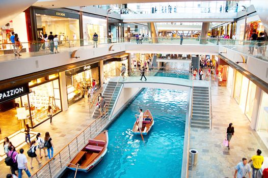 Singapore, Republic of Singapore - March 08, 2013: People walking in a shopping mall at Marina Bay Sands Resort in Singapore. It is billed as the world's most expensive standalone casino property at S$8 billion .