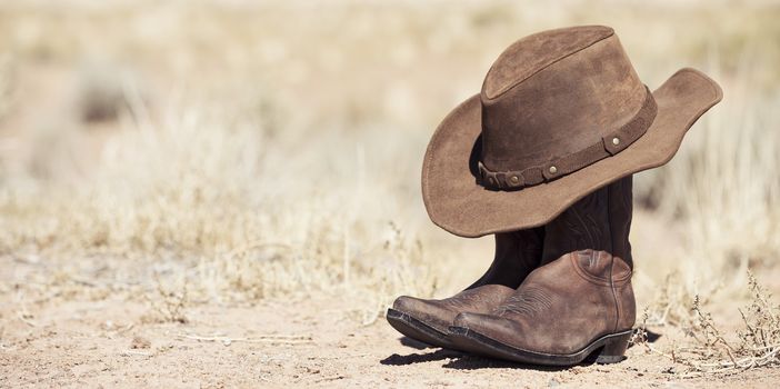 brown cowboy hat and boots outdoor, panoramic view