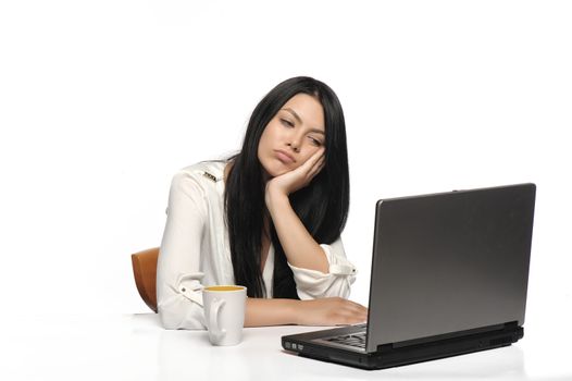 Bored business woman working on laptop looking very boring at the computer, Isolated white background