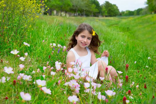 beautiful children girl on spring meadow with poppy flowers