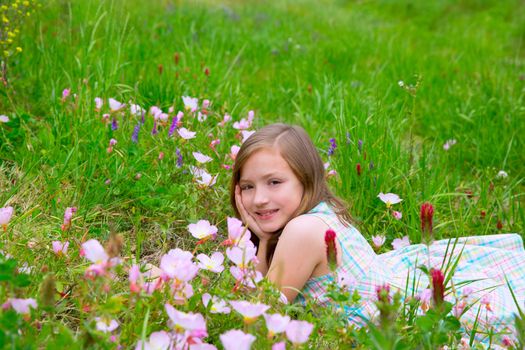 beautiful children girl on spring meadow with poppy flowers