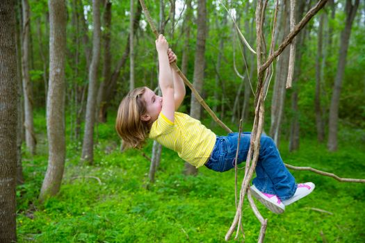 children girls playing hanging and climbing from lianas at the jungle forest park outdoor