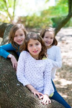 friends sister girls resting on tree trunk nature outdoor